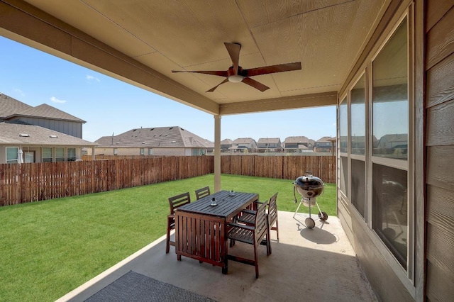 view of patio with a fenced backyard, a residential view, a ceiling fan, and outdoor dining area