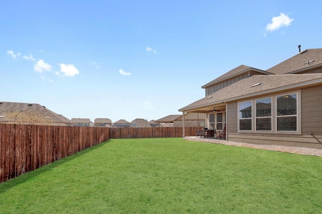 view of yard featuring a fenced backyard, a patio area, and a ceiling fan