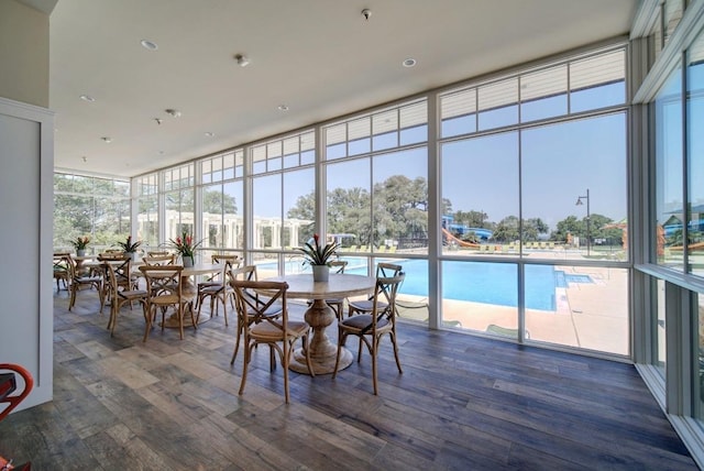 dining area featuring wood finished floors and floor to ceiling windows