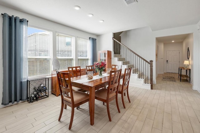 dining room with recessed lighting, light wood-style floors, visible vents, and stairs