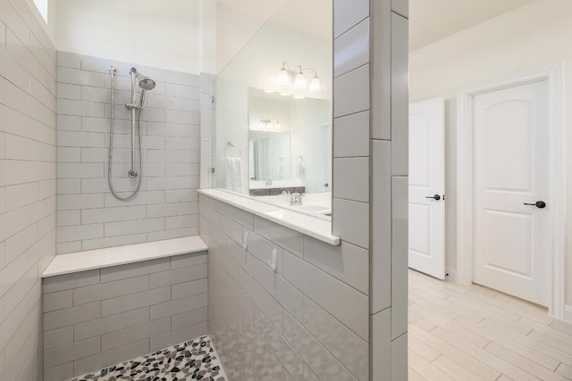full bath featuring a sink and tiled shower
