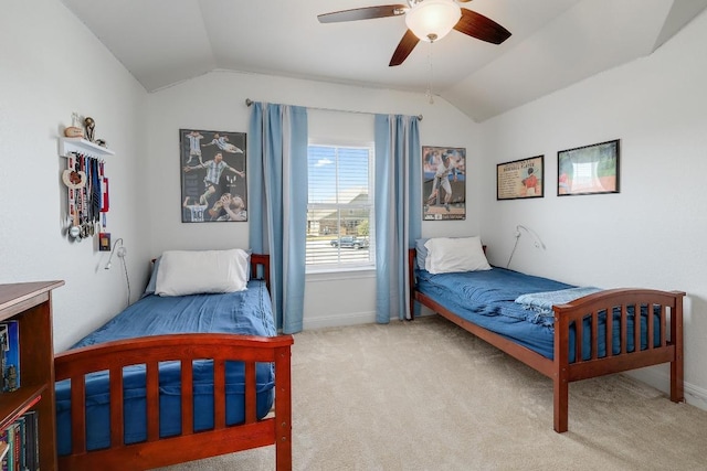 carpeted bedroom with vaulted ceiling, baseboards, and ceiling fan
