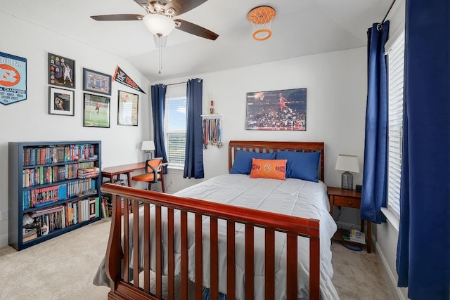 carpeted bedroom featuring lofted ceiling and a ceiling fan