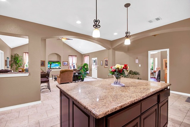 316 County Rd, Bastrop, TX 78602 - kitchen featuring vaulted ceiling, open floor plan, decorative light fixtures, ceiling fan, and light tile patterned floors