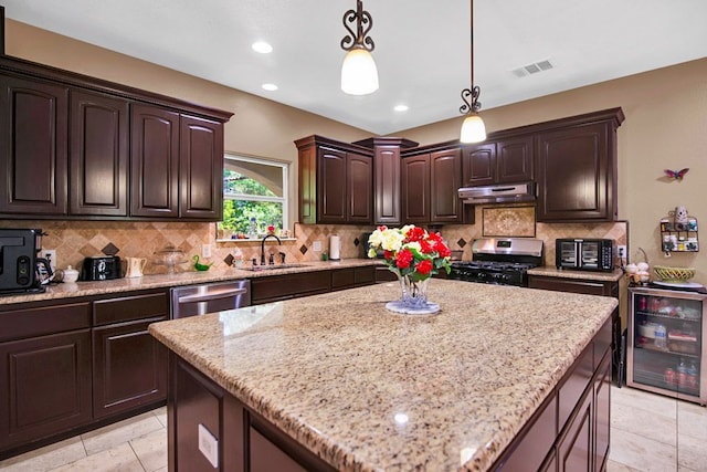 316 County Rd, Bastrop, TX 78602 - kitchen with appliances with stainless steel finishes, under cabinet range hood, light stone counters, tasteful backsplash, and recessed lighting