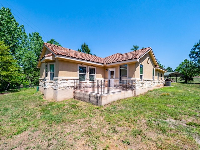 316 County Rd, Bastrop, TX 78602 - rear view of property featuring stone siding, stucco siding, and a tiled roof