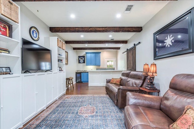 living room featuring dark wood-style floors, a barn door, visible vents, recessed lighting, and beamed ceiling