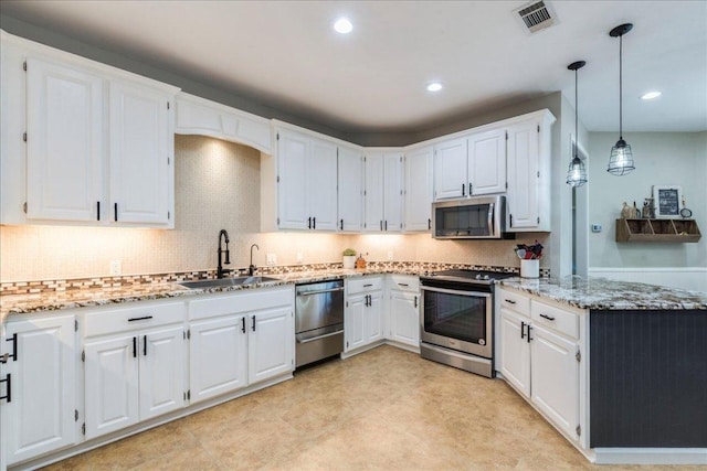 kitchen featuring white cabinets, stainless steel appliances, a sink, visible vents, and light stone countertops