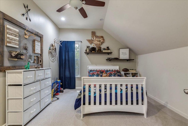carpeted bedroom featuring lofted ceiling, a ceiling fan, and baseboards