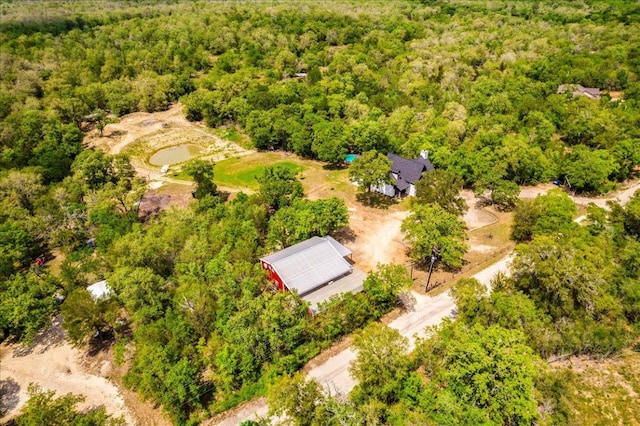 bird's eye view with a wooded view
