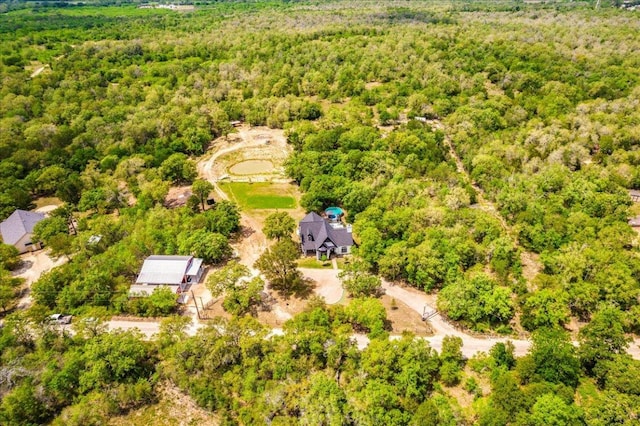 bird's eye view featuring a wooded view