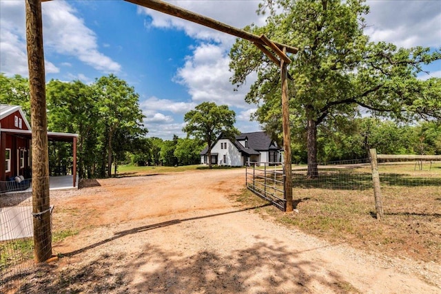 view of yard with driveway and fence