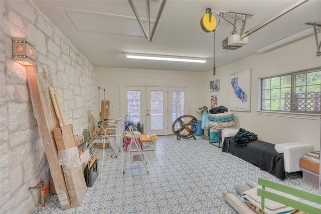 garage with a garage door opener and french doors