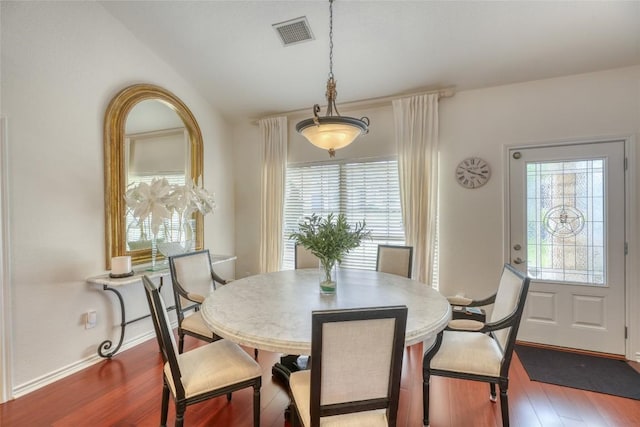 dining space with baseboards, wood finished floors, and visible vents