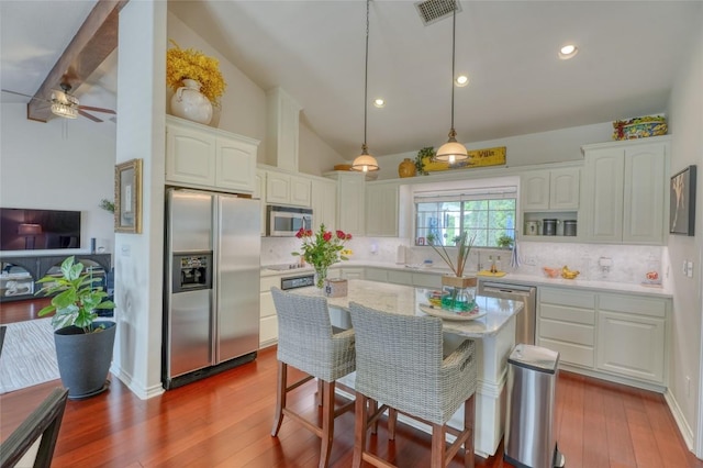 kitchen with white cabinets, visible vents, backsplash, a ceiling fan, and appliances with stainless steel finishes