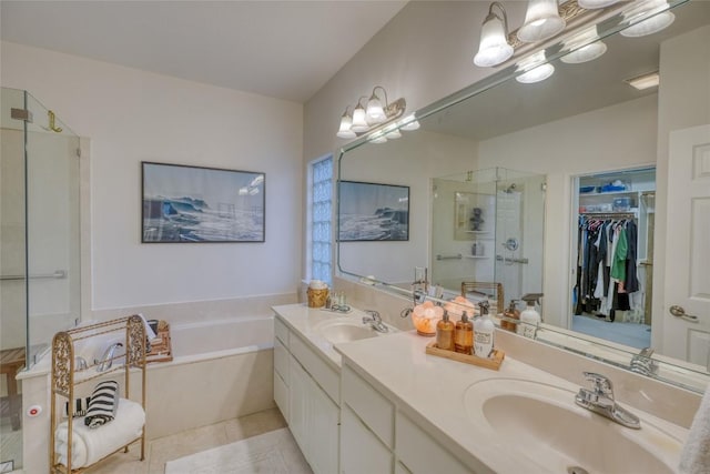 full bathroom with a bath, a sink, double vanity, and a stall shower