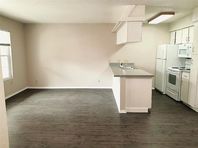 910 Duncan Ln Unit 27, Austin, TX 78705 - kitchen featuring white appliances, dark wood-style floors, white cabinetry, a peninsula, and a textured ceiling