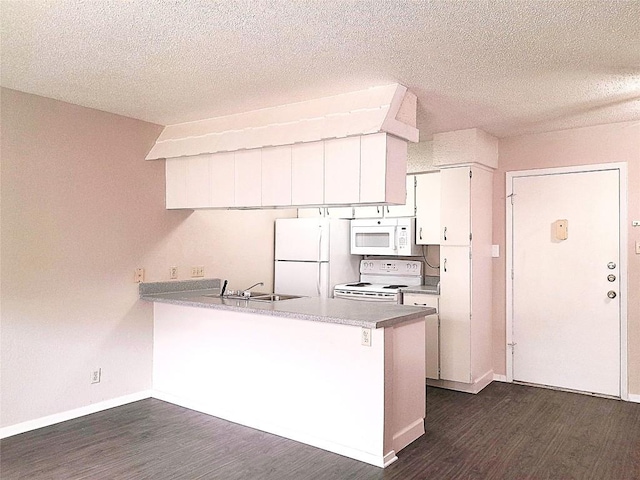 910 Duncan Ln Unit 27, Austin, TX 78705 - kitchen featuring white appliances, dark wood-style flooring, a peninsula, a textured ceiling, and white cabinetry