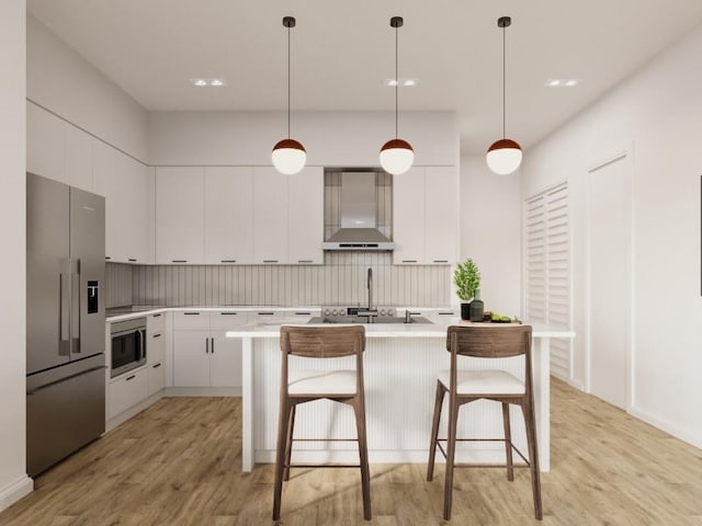 kitchen featuring light wood-style flooring, wall chimney exhaust hood, appliances with stainless steel finishes, and modern cabinets