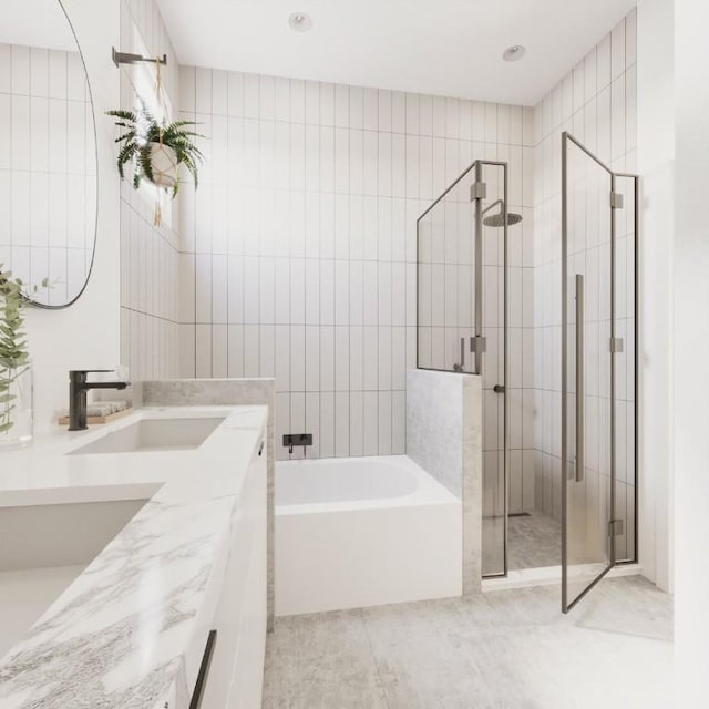 bathroom featuring a bath, a sink, a shower stall, and double vanity