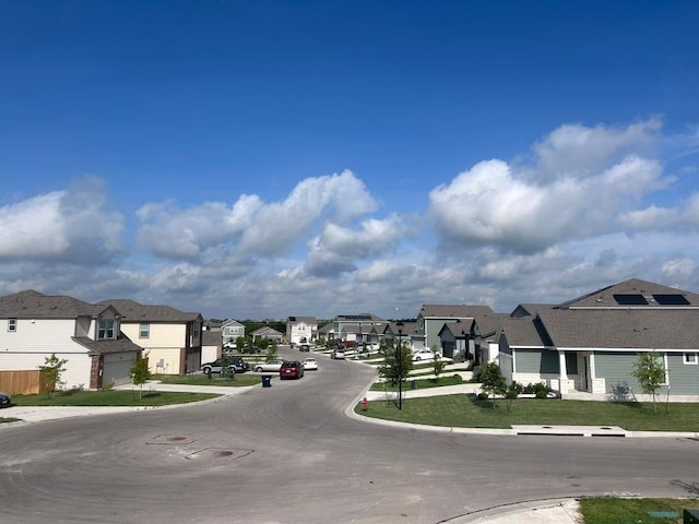 view of street featuring curbs and a residential view