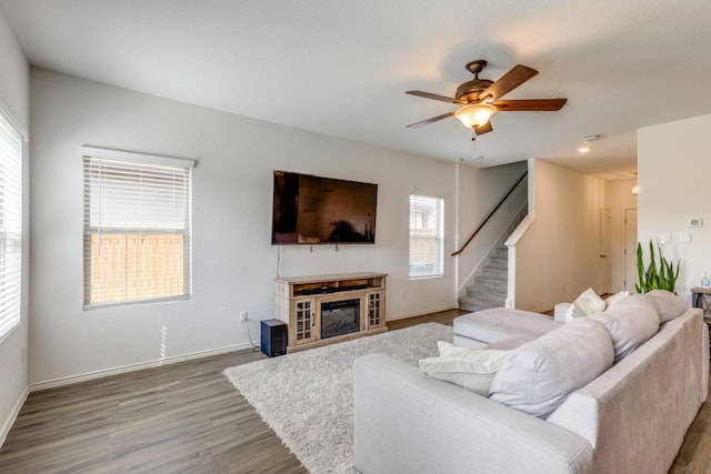 532 Greatest Gift Way, Jarrell, TX 76537 - living room with wood finished floors, healthy amount of natural light, stairs, and ceiling fan