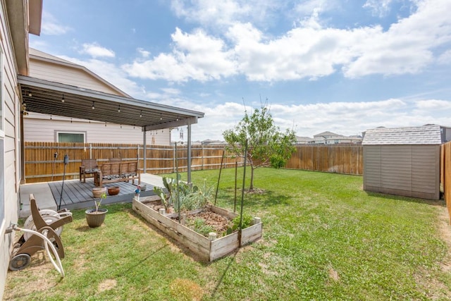 view of yard featuring a fenced backyard, a vegetable garden, a storage unit, and an outdoor structure