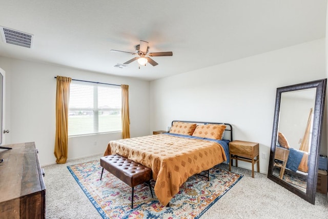 carpeted bedroom featuring visible vents, baseboards, and ceiling fan