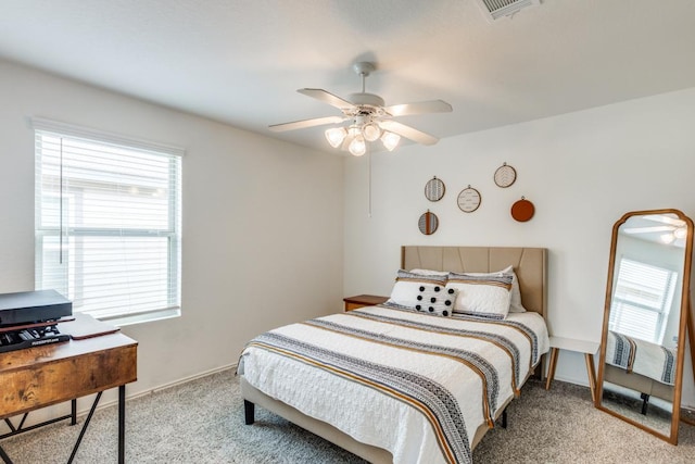 carpeted bedroom with visible vents, baseboards, and ceiling fan