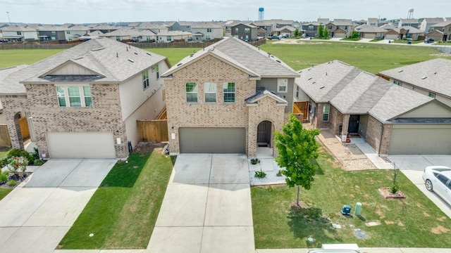 532 Greatest Gift Way, Jarrell, TX 76537 - view of front of home featuring a residential view, concrete driveway, and an attached garage