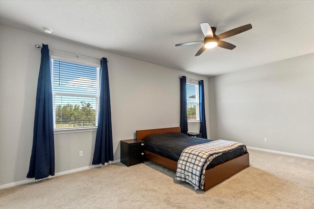 609 Bluffview Dr, Bastrop, TX 78602 - carpeted bedroom with multiple windows, a ceiling fan, and baseboards