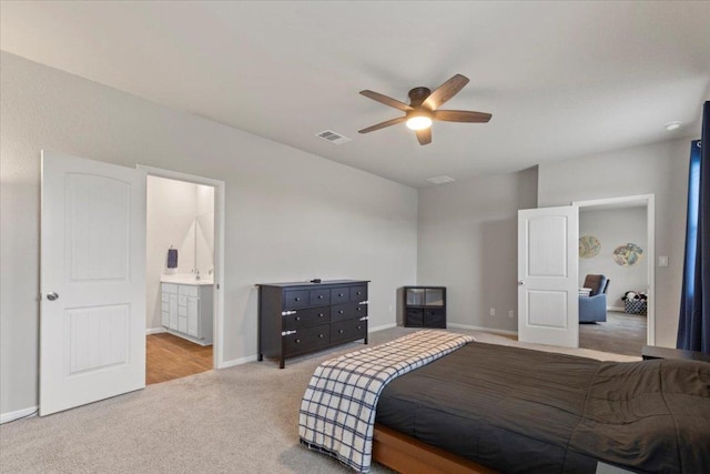 609 Bluffview Dr, Bastrop, TX 78602 - carpeted bedroom featuring baseboards, ensuite bathroom, and ceiling fan