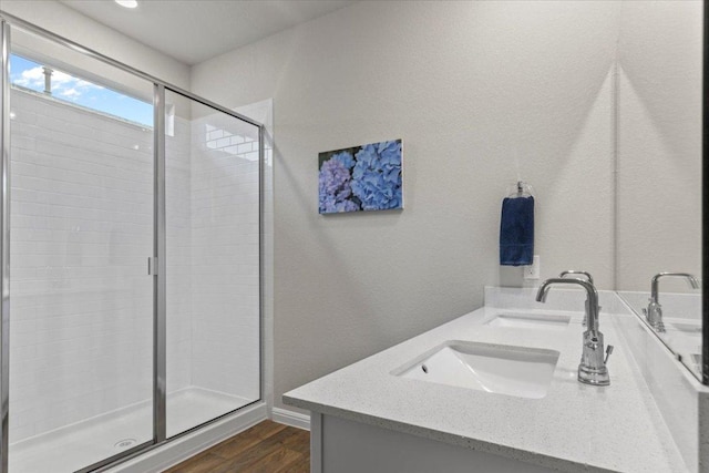 609 Bluffview Dr, Bastrop, TX 78602 - bathroom featuring double vanity, a shower stall, and wood finished floors