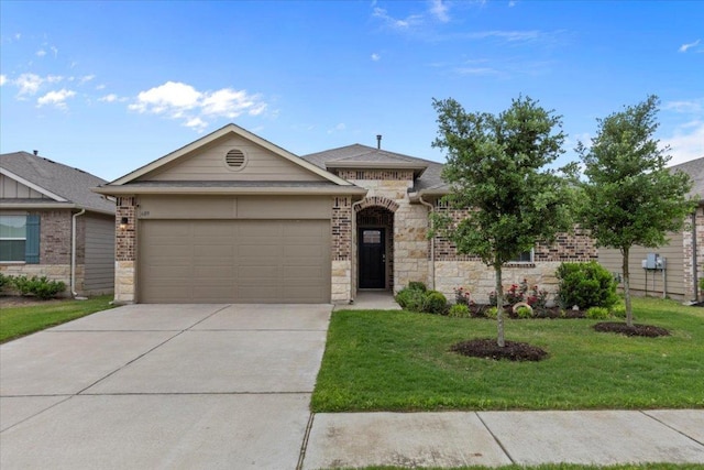 609 Bluffview Dr, Bastrop, TX 78602 - view of front of house featuring an attached garage, concrete driveway, a front lawn, and stone siding