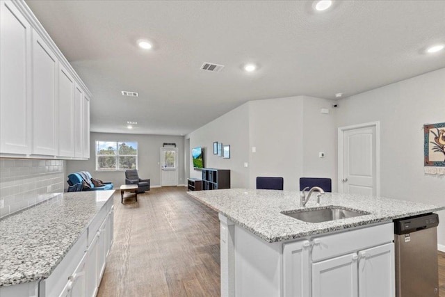 609 Bluffview Dr, Bastrop, TX 78602 - kitchen with dishwasher, a sink, light wood finished floors, open floor plan, and recessed lighting
