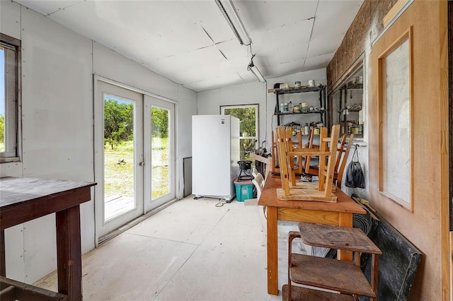 office space with french doors and concrete floors