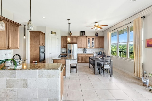 1204 Ogden Dr, Austin, TX 78733 - kitchen featuring tasteful backsplash, a ceiling fan, brown cabinets, and recessed lighting