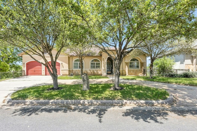 1204 Ogden Dr, Austin, TX 78733 - view of front of property with curved driveway, stucco siding, and a garage