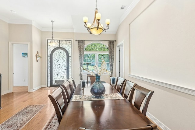 1204 Ogden Dr, Austin, TX 78733 - dining space with a chandelier, wood finished floors, and crown molding