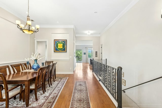 1204 Ogden Dr, Austin, TX 78733 - dining area featuring a chandelier, light wood-style floors, and ornamental molding