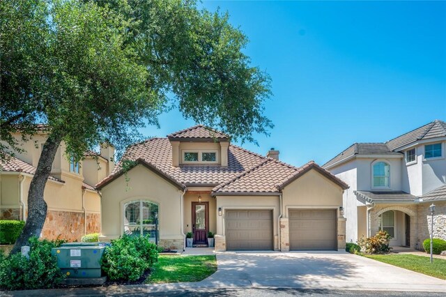 15 Chandon Ln, Lakeway, TX 78734 - mediterranean / spanish house featuring a garage, stone siding, stucco siding, and concrete driveway