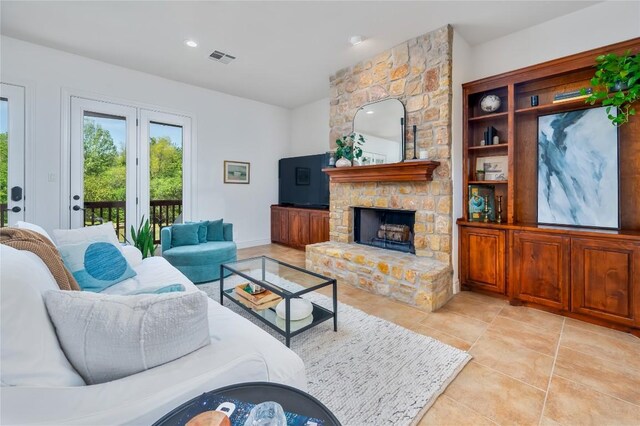 15 Chandon Ln, Lakeway, TX 78734 - living room featuring a stone fireplace, light tile patterned flooring, and recessed lighting