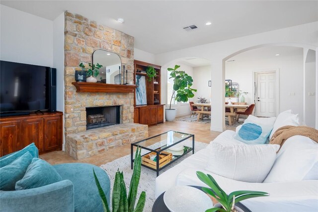 15 Chandon Ln, Lakeway, TX 78734 - living room featuring arched walkways, a fireplace, and recessed lighting