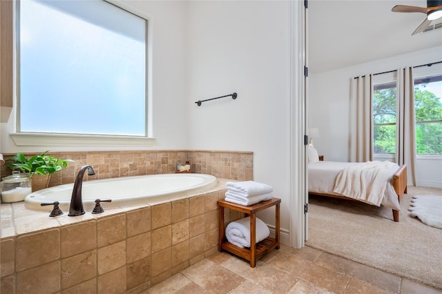 15 Chandon Ln, Lakeway, TX 78734 - full bath featuring a bath, connected bathroom, stone finish floors, and a ceiling fan
