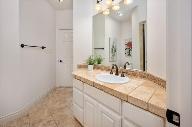 15 Chandon Ln, Lakeway, TX 78734 - bathroom with vanity, tile patterned floors, and baseboards
