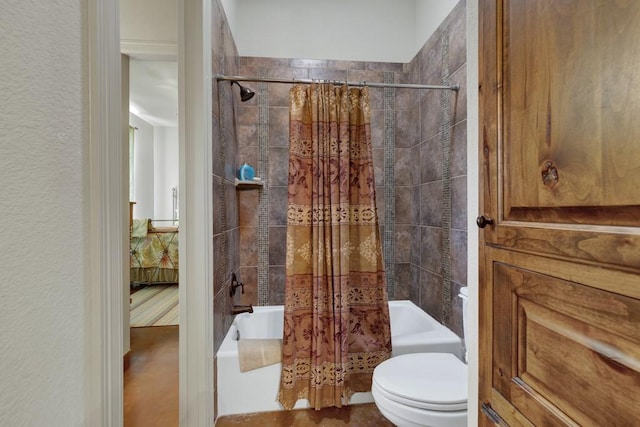 ensuite bathroom with a textured wall, ensuite bathroom, shower / tub combo with curtain, and toilet