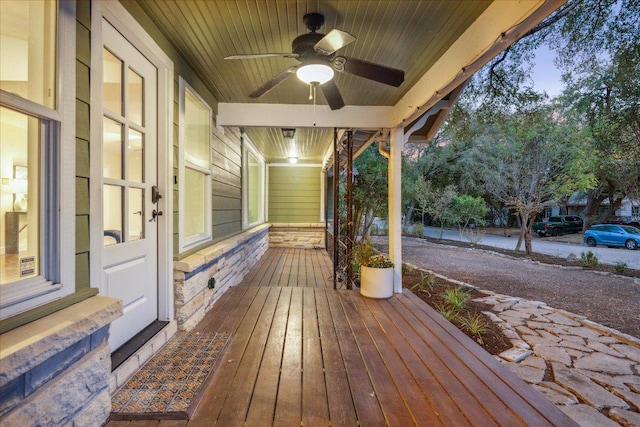 wooden deck featuring a ceiling fan and a porch