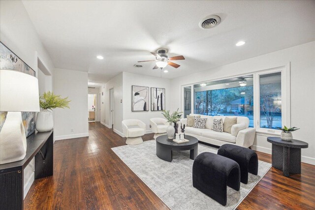 living area featuring ceiling fan, baseboards, wood finished floors, and visible vents