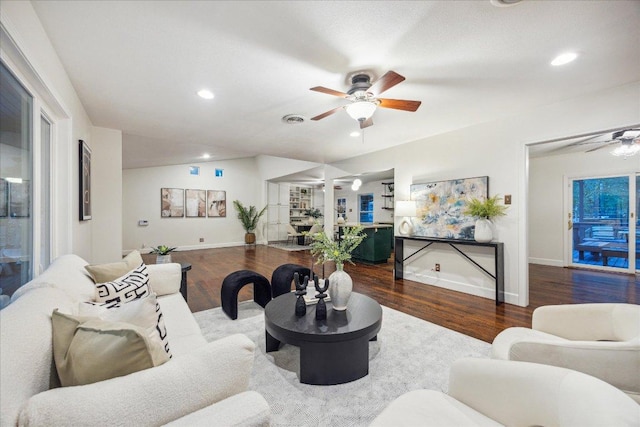 living area featuring baseboards, a ceiling fan, wood finished floors, and visible vents