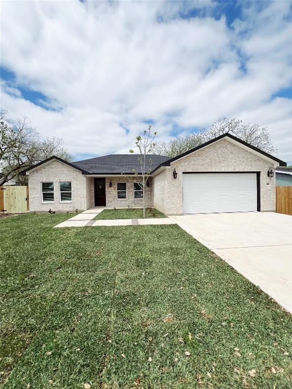 ranch-style house with fence, driveway, brick siding, a front yard, and a garage